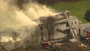 Firefighters battle the blaze at the Caneiro mansion in Colts Neck on November 20, 2018
