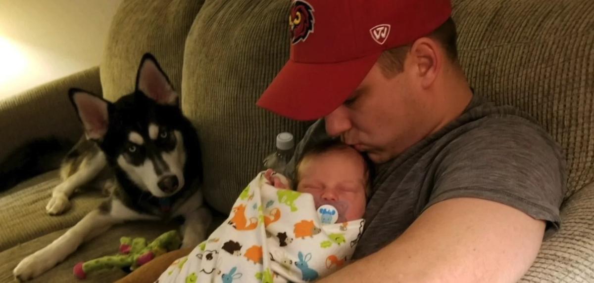 Tom Imschweiler holding his infant son Franklin before the tragedy