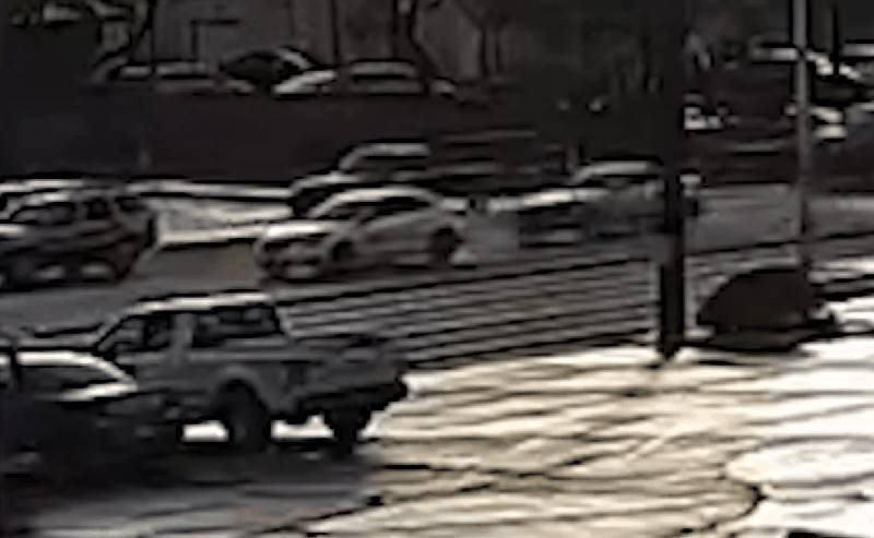 Surveillance footage showing vehicles at intersection moments before crash