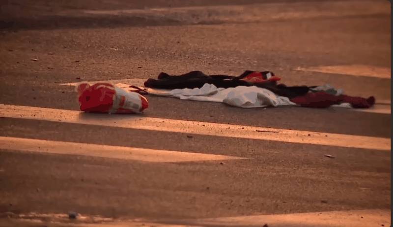 Debris and clothing scattered on roadway at crash scene