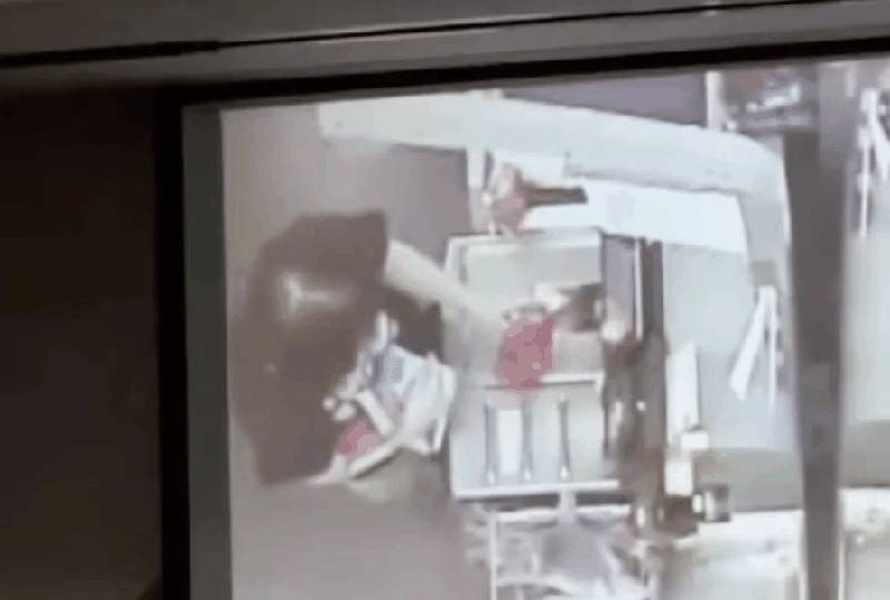 Walmart surveillance showing Tara King at self-checkout scanning hair dye