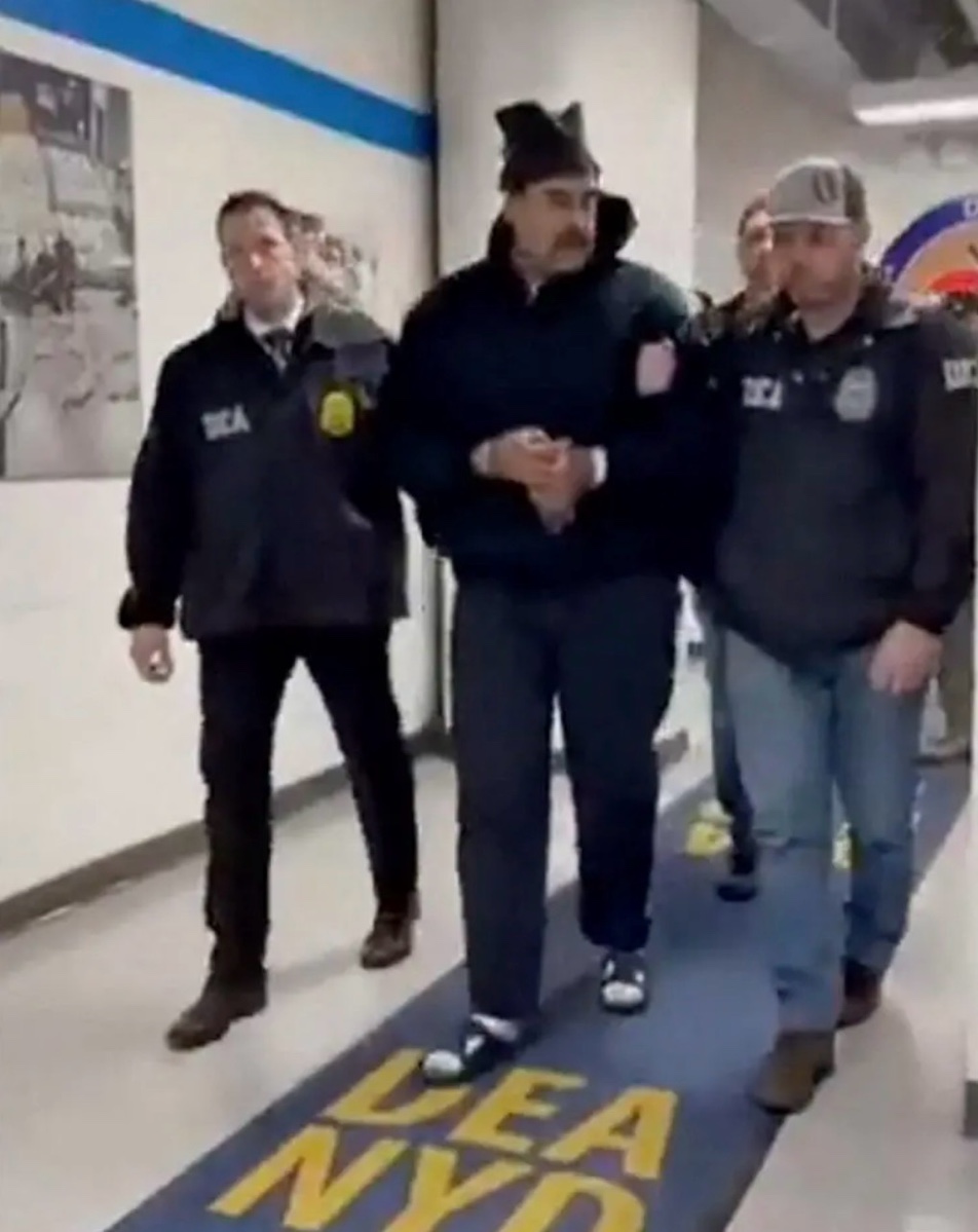 Nicolás Maduro being escorted by DEA agents through the DEA New York Division office