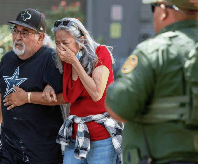 Grieving family members outside Robb Elementary School