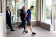 Brendan Banfield being led away in handcuffs after his arrest